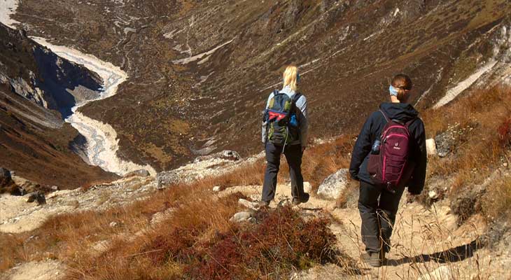 A couple of person is getting down from Kyangzing ri during Langtang region trek